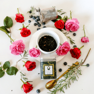 Loose leaf black tea in a cup surrounded with red and pink roses