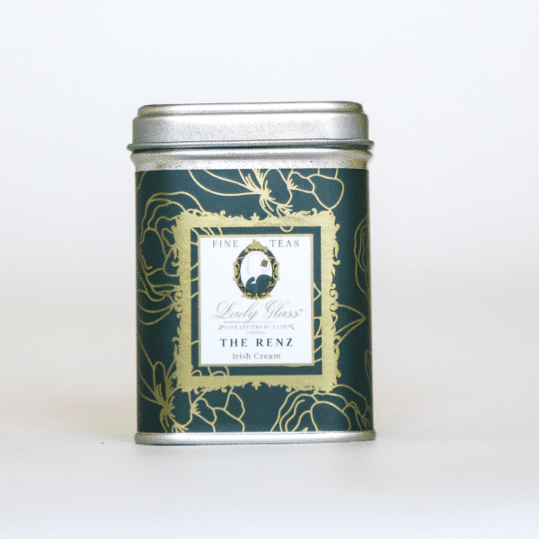 Loose leaf black tea in a green tin on a white background