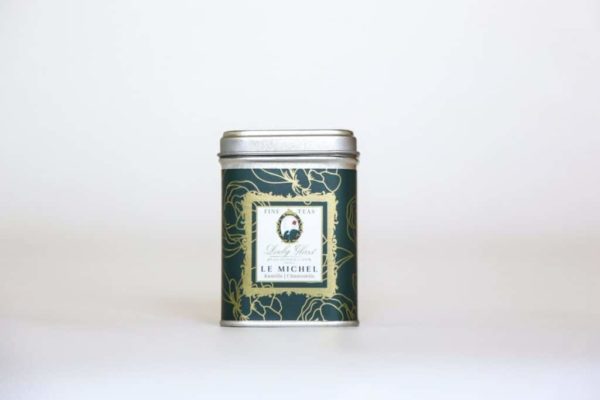 Premium whole buds chamomile tea in a green tea caddy on a white background